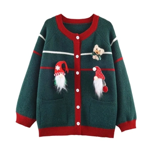 Detail of Christmas cardigan with 3D gnome pendants and teddy bear on green knitwear