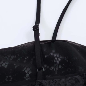 Close-up of adjustable strap and intricate black lace fabric on this stylish top