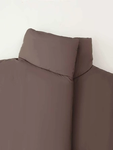 Detail shot of a dark coffee puffer coat featuring thick padding and a stand-up collar