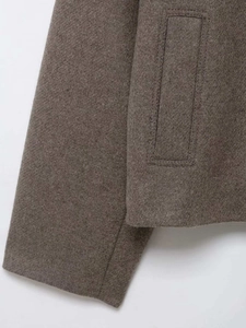 Close-up of wool texture and vertical welt pocket on vintage short jacket coat