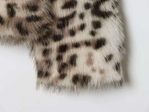 Close-up of soft leopard print faux fur texture with detailed brown and beige fibers