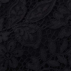 Macro detail of high-quality black lace fabric with intricate floral and leaf crochet patterns