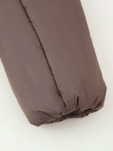 Detailed close-up of dark brown padded jacket sleeve with elastic windproof cuff
