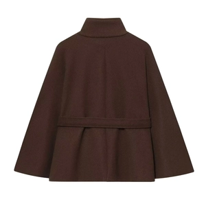 Detail view of the back of a dark brown cape coat featuring a stand collar and pleat details