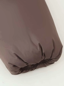 Detail of windproof elastic cuff on dark coffee quilted jacket with matte texture
