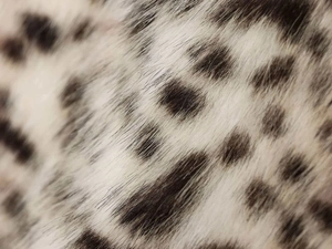 Detailed macro view of soft faux fur texture with high-density black and white spots