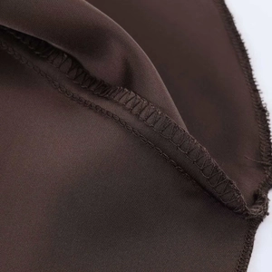 Gros plan détaillé des coutures intérieures d'une robe en satin marron de qualité