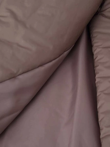 Close-up of khaki stand collar jacket showing smooth inner lining and warm filling detail