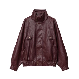 Detail of burgundy faux leather jacket featuring stand collar with metal snap buttons