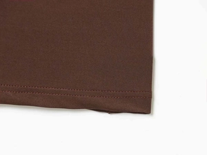 Detail showing the double-stitched hem and satin texture of the brown slim maxi dress