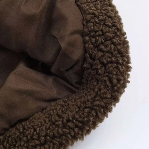 Detail shot of winter coat featuring warm brown fleece texture and smooth inner lining