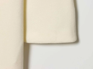 Detail of the high-quality wool coat sleeve showing precise stitching and fabric texture