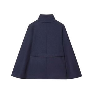 Detail view of the navy blue wool cape coat showing its A-line shape and back belt detail