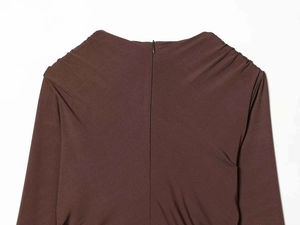 Detail of deep V-neck back with invisible zipper and elegant pleated shoulder seams