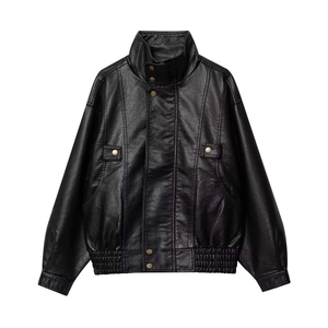 Detail of vintage black faux leather jacket with stand collar and metallic button pockets