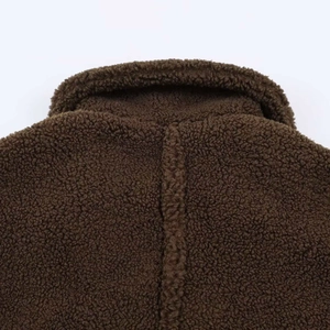 Close-up of the plush dark brown fleece texture and neckline stitching on this winter coat