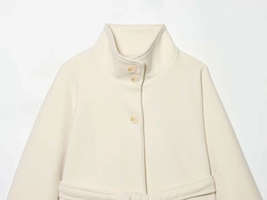 Detailed view of cream wool cape coat featuring stand collar and amber-style buttons