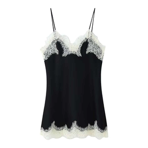 Elegant black spaghetti strap top with white lace trim details in minimalist style