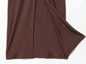 Detail of dark brown satin dress showing a slit design and premium side seam stitching