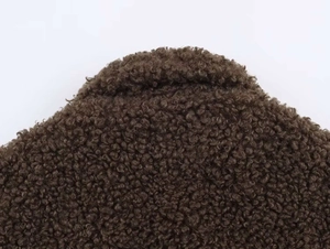 Detail shot of heavy brown fleece texture on a casual winter long jacket