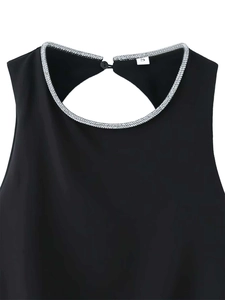 Detail of black top neckline with silver rhinestone embellishment and button closure