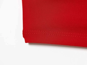 Detail of red mesh sleeveless dress showing breathable fabric and double-stitch seams