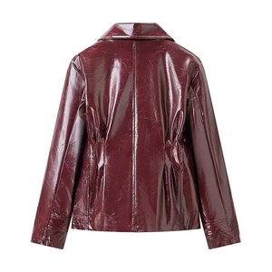 Detail view of the back of a glossy burgundy faux leather jacket with seam stitching