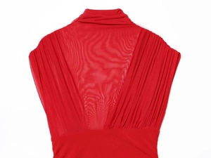Detailed macro view of the sheer mesh and pleated fabric on the red sleeveless dress