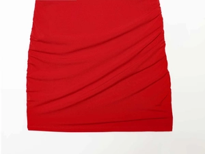 Detail shot of a red slim-fit skirt featuring textured ruching and side drawstring details