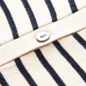 Macro detail of navy striped knit cardigan with silver round metal button closure
