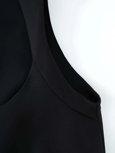 Detail of high-quality black sleeveless top showing neat stitching and smooth fabric texture