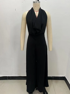 Detail view of black halter neck jumpsuit with elegant wide-leg cut and draped fabric