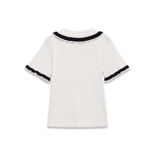 Detail view of white knitted top showing navy-style sailor collar and striped cuffs