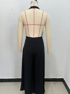 Detail of the black halter neck backless design with a smooth crepe fabric texture