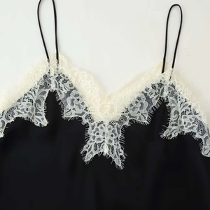 Elegant black camisole with white eyelash lace trim and thin adjustable straps