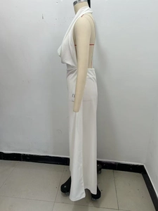 Detail view of white halter neck jumpsuit with backless design and draped fabric texture