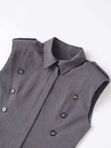 Detail of grey double-breasted vest dress with notched lapels and twill texture