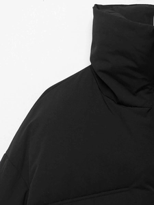 Detail of high collar and quilted shoulder seams on black padded winter jacket