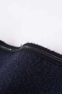 Detailed close-up of navy blue wool texture and matching zipper on a strapless top