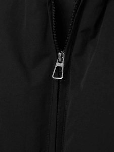 Detailed macro view of a silver metal zipper on a black winter padded jacket