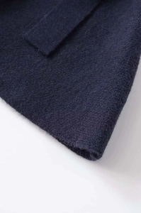 Detailed close-up of navy blue knit fabric showing soft texture and premium quality finish
