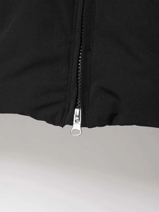 Detail shot of the silver metal ring zipper on a black winter padded puffer jacket