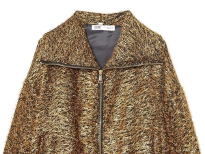 Close-up of metallic gold bomber jacket fabric texture with YHWM brand label and size tag
