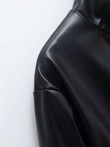 Close-up of lapel and shoulder seam on a black faux leather jacket for women