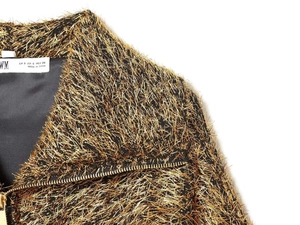Detail of metallic gold fringe fabric on pilot jacket with high-quality metal zipper