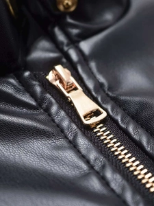 Close-up detail of high-quality black leather jacket with polished golden zipper teeth