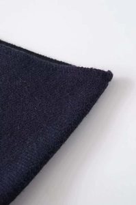 Macro shot of navy blue strapless top fabric with soft texture and refined stitching