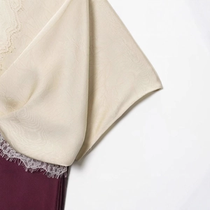Elegant midi dress with delicate beige eyelash lace and smooth burgundy satin fabric