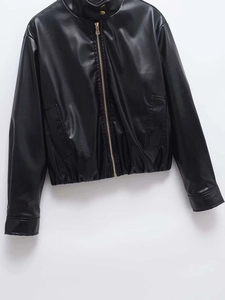 Detail of black faux leather biker jacket featuring a metal zipper and snap-button collar