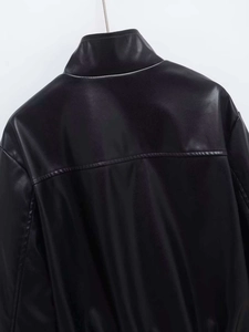 Detail view of the back seams and high-quality faux leather texture on black jacket
